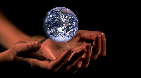 The earth hovering above a pair of hands.