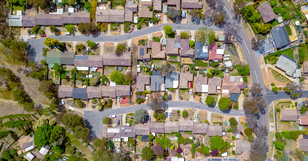 Aerial view of streets, cul-de-sacs, rooftops and parklands.
