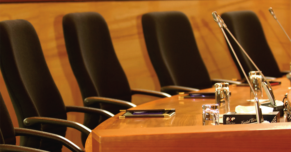 Empty seats in a council chamber.