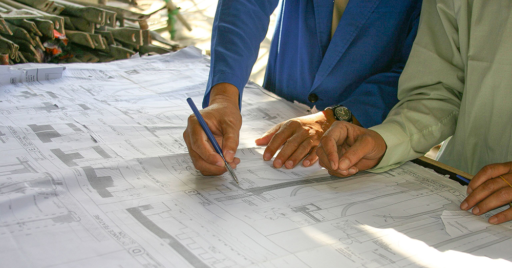 Draftsmen looking at building plans.