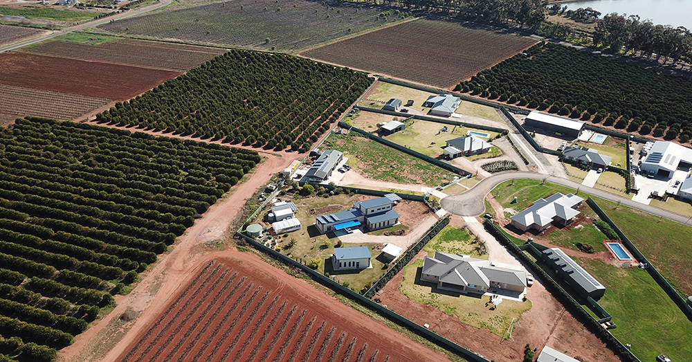 Aerial view of a farm showing buildings and cultivated paddocks.