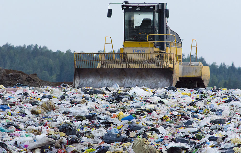 A dozer pushes rubbish at a waste disposal facility.
