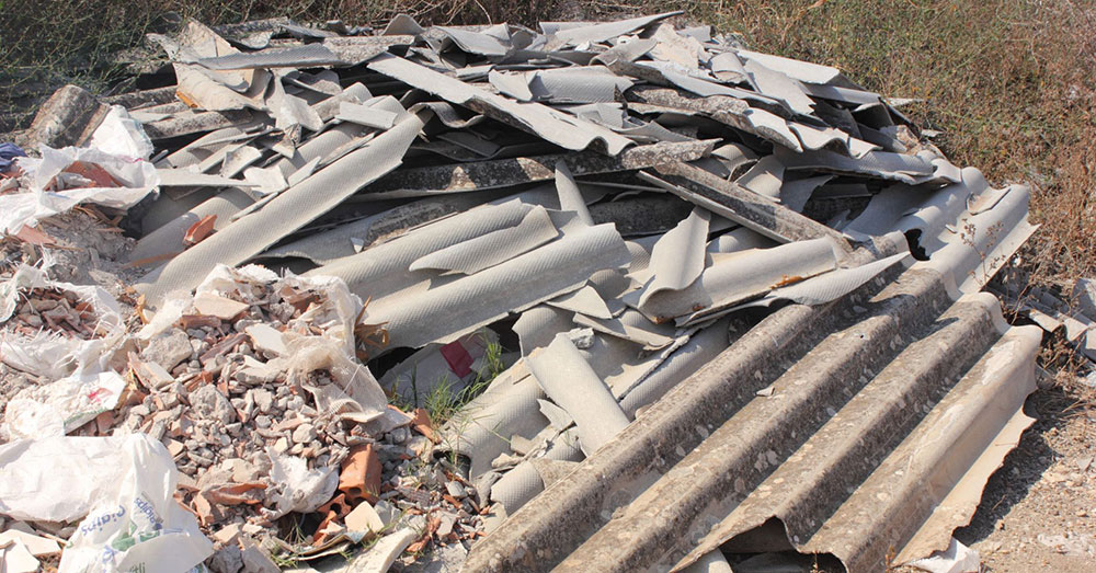 A pile of asbestos material dumped in the bush.