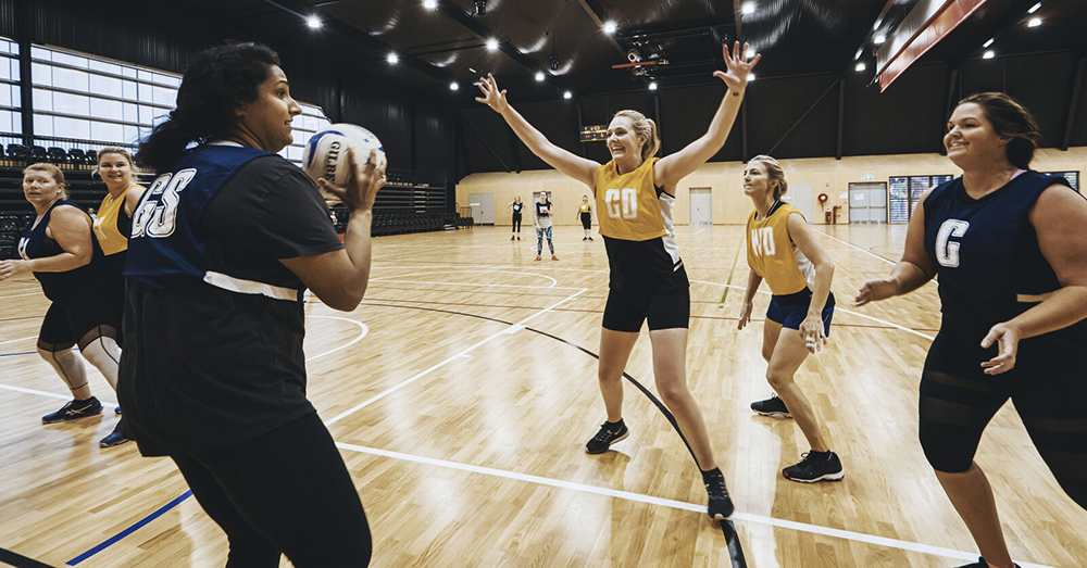 Young women playing netball.
