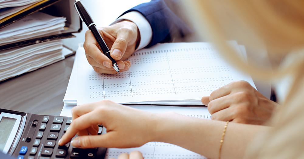 Office staff with a calculator and business papers.