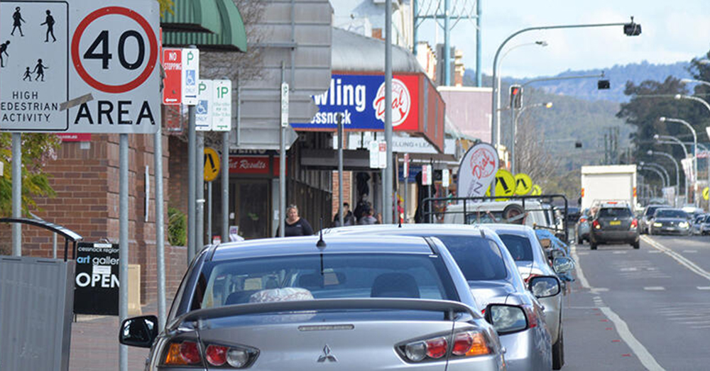 Suburban streetscape with a 40km/h speed sign.
