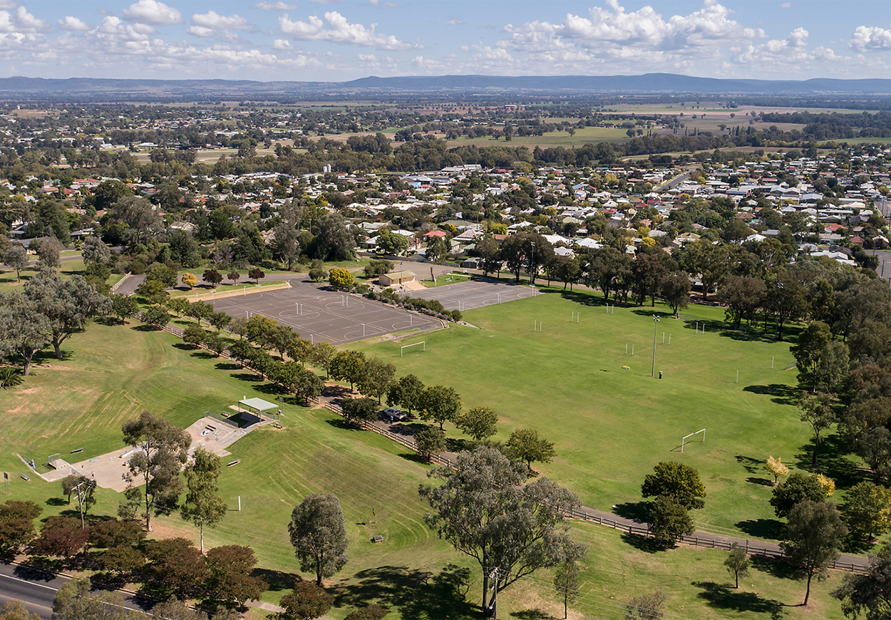 Aerial shot of green soccer fields and basketball court.