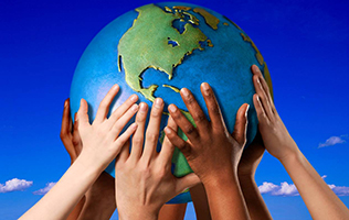 Different coloured hands holding a globe