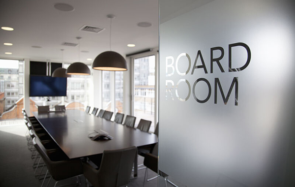 Picture of a board room, with a glass door sporting board room.