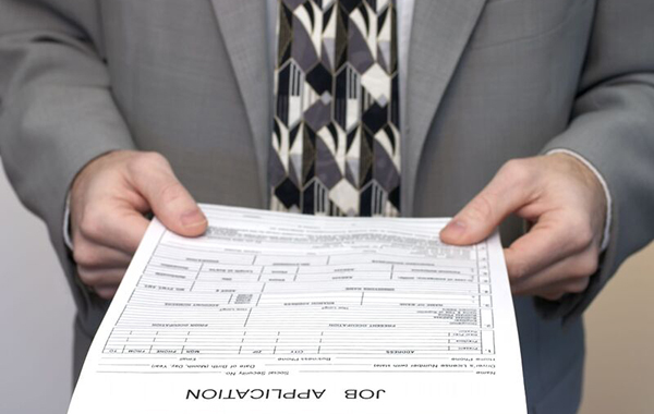 A man holding a job application form.