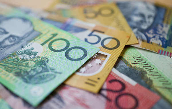 Series of Australian currency notes scattered on a flat surface.